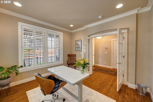 office area with wood finished floors, ornamental molding, and french doors