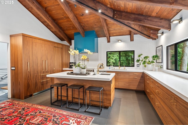 3777 Parkwood Way W, Linn, OR 97068 - kitchen with wooden ceiling with exposed beams, light countertops, a sink, high vaulted ceiling, and a center island with sink