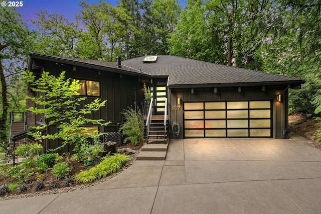 3777 Parkwood Way W, Linn, OR 97068 - view of front facade featuring board and batten siding, roof with shingles, driveway, and a garage