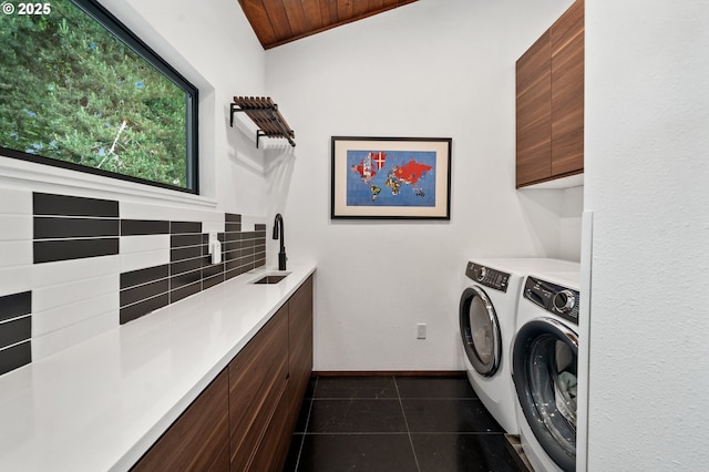 3777 Parkwood Way W, Linn, OR 97068 - laundry room with washing machine and clothes dryer, cabinet space, dark tile patterned floors, baseboards, and wooden ceiling