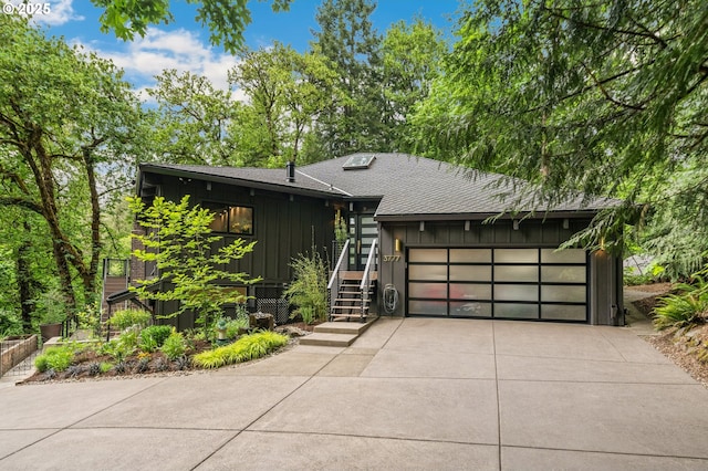 3777 Parkwood Way W, Linn, OR 97068 - view of front facade featuring board and batten siding, concrete driveway, roof with shingles, and a garage