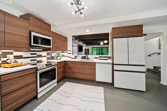 3777 Parkwood Way W, Linn, OR 97068 - kitchen featuring appliances with stainless steel finishes, modern cabinets, tasteful backsplash, and light countertops