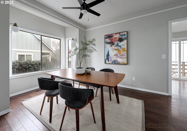 dining area with crown molding, wood finished floors, baseboards, and ceiling fan