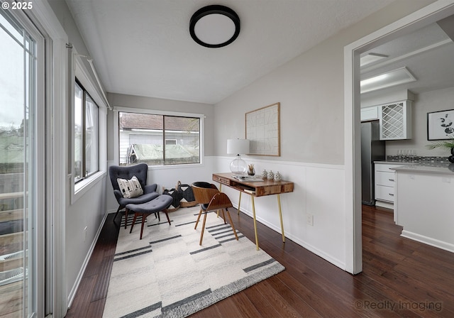 sitting room with dark wood finished floors and wainscoting