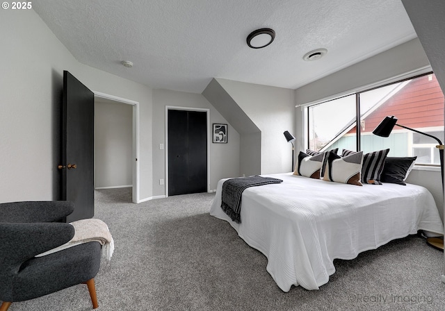 bedroom featuring baseboards, carpet, visible vents, and a textured ceiling