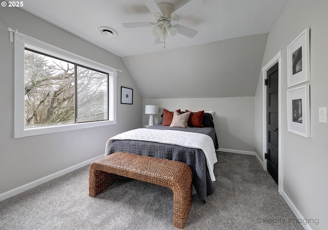 carpeted bedroom featuring visible vents, ceiling fan, baseboards, and vaulted ceiling