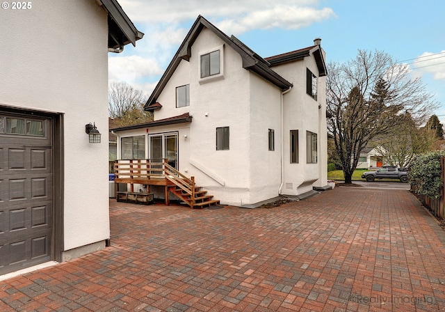 rear view of property with stucco siding