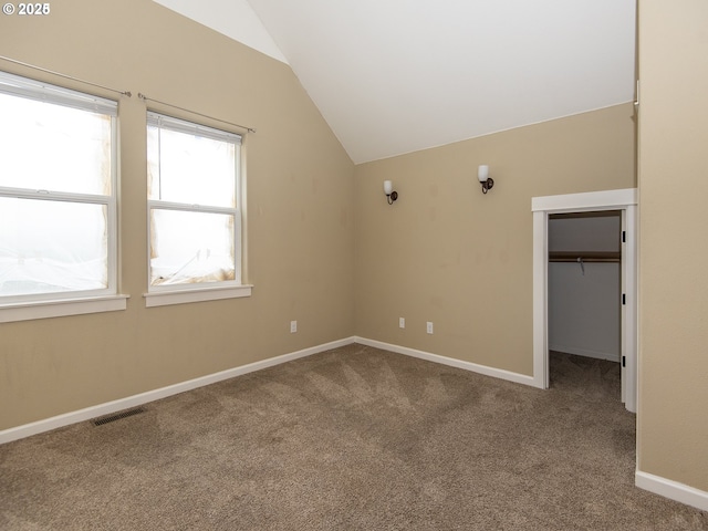 interior space with vaulted ceiling, baseboards, and visible vents