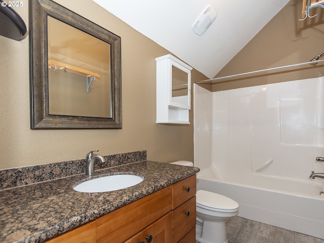 full bathroom with shower / bathing tub combination, lofted ceiling, toilet, and vanity