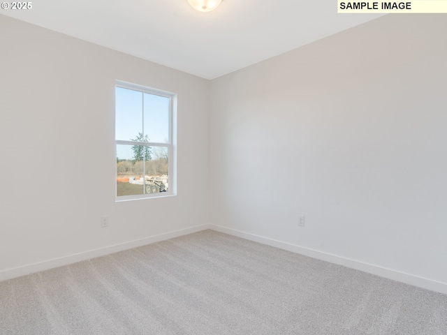 empty room featuring baseboards and carpet flooring