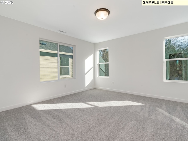 empty room featuring carpet floors and baseboards