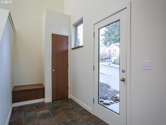 interior space featuring stone finish flooring and baseboards