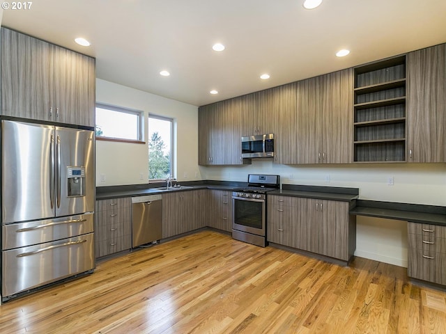 kitchen with open shelves, dark countertops, modern cabinets, and stainless steel appliances