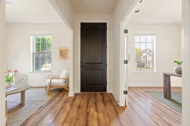 entryway with wood finished floors and baseboards
