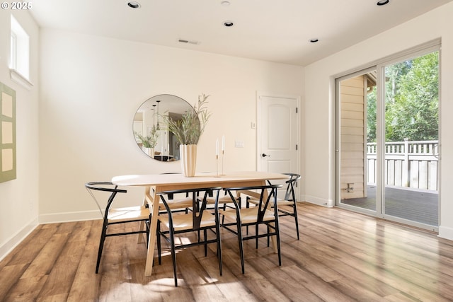 dining space with light wood finished floors, baseboards, visible vents, and recessed lighting