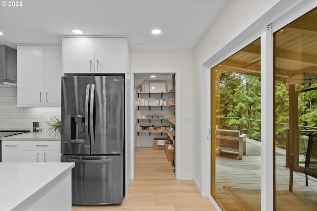 9990 SW Morrison St, Portland, OR 97225 - kitchen with stainless steel refrigerator with ice dispenser, tasteful backsplash, light wood-style flooring, light countertops, and white cabinetry