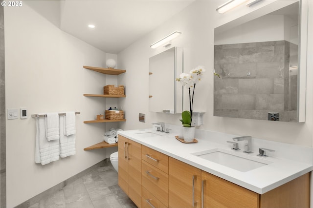 9990 SW Morrison St, Portland, OR 97225 - full bathroom featuring toilet, double vanity, baseboards, recessed lighting, and marble look tiles