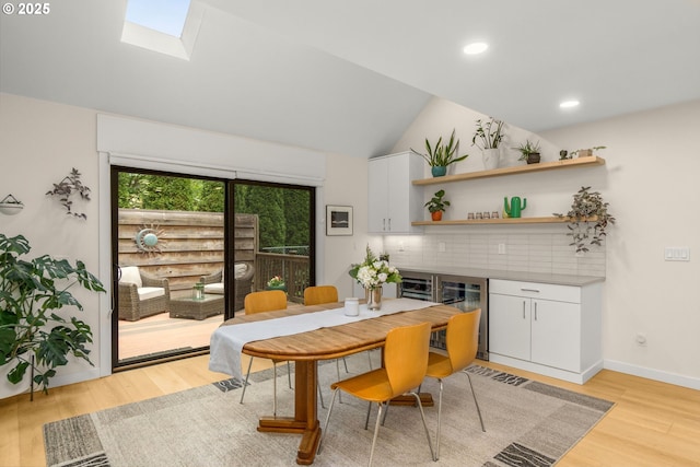 9990 SW Morrison St, Portland, OR 97225 - dining room featuring light wood-style floors, beverage cooler, vaulted ceiling, recessed lighting, and a bar