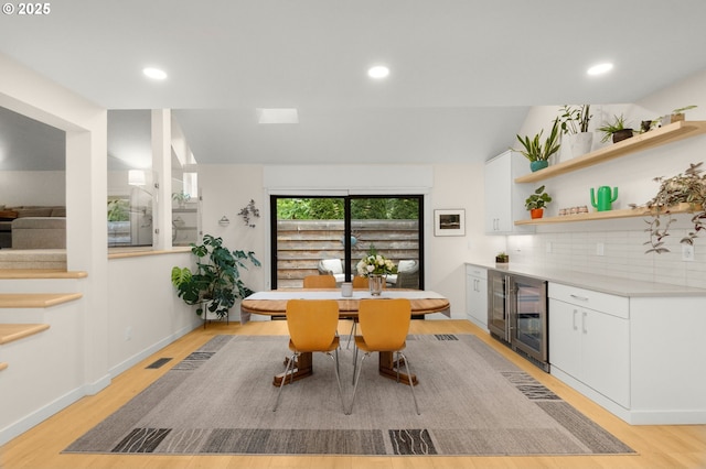 9990 SW Morrison St, Portland, OR 97225 - dining room featuring wine cooler, light wood finished floors, a dry bar, recessed lighting, and lofted ceiling