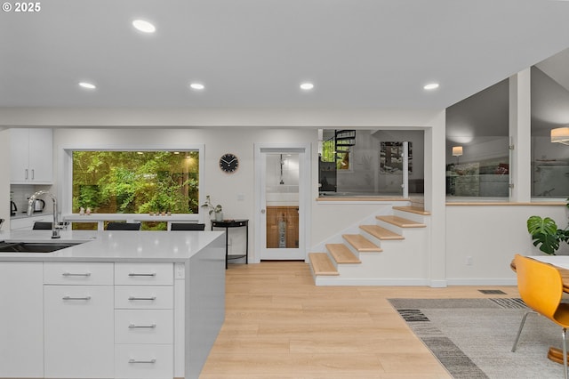 9990 SW Morrison St, Portland, OR 97225 - kitchen with a sink, recessed lighting, healthy amount of natural light, light countertops, and light wood-style floors