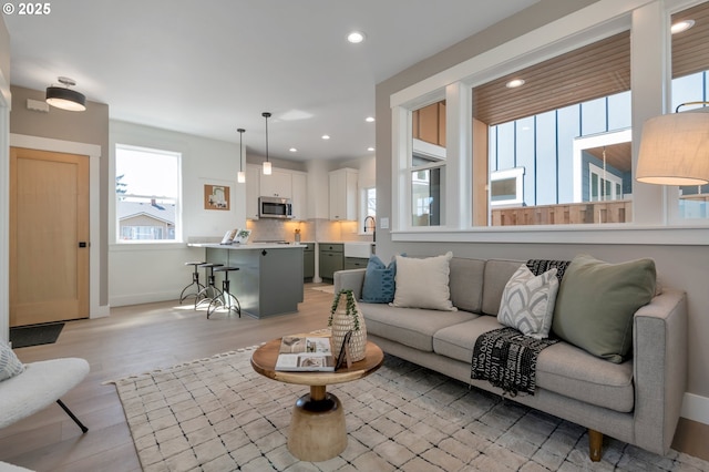7257 SE Duke St Unit 3, Portland, OR 97206 - living area with plenty of natural light, recessed lighting, light wood-style floors, and baseboards