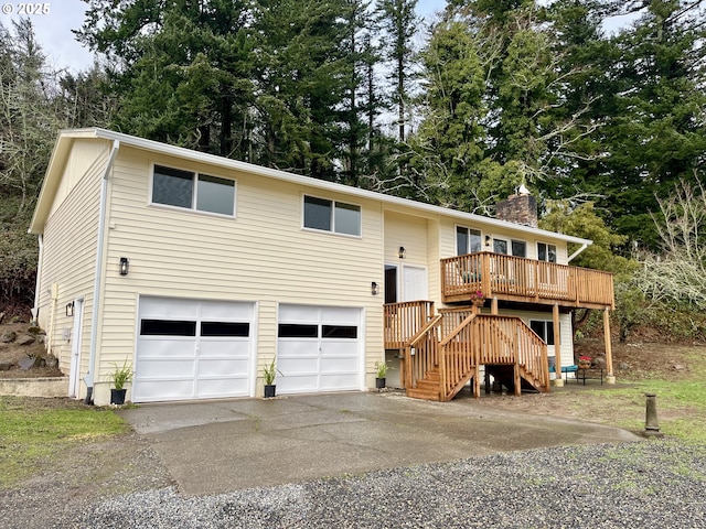 bi-level home with a garage and a wooden deck