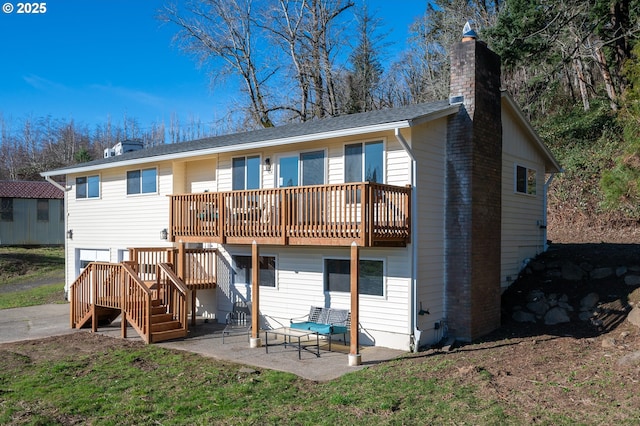 rear view of house with a deck, a chimney, a patio area, and stairs