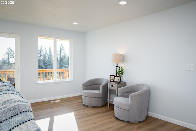 living area featuring recessed lighting, visible vents, baseboards, and wood finished floors