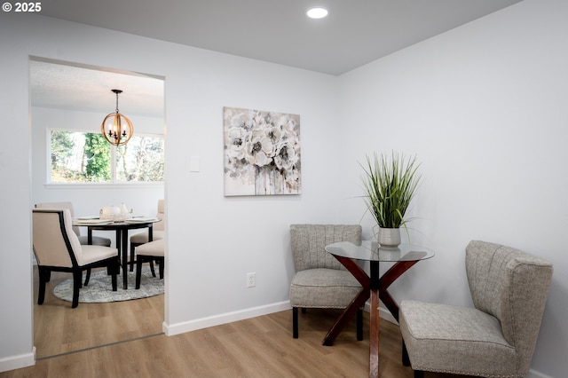 sitting room with baseboards, a chandelier, wood finished floors, and recessed lighting