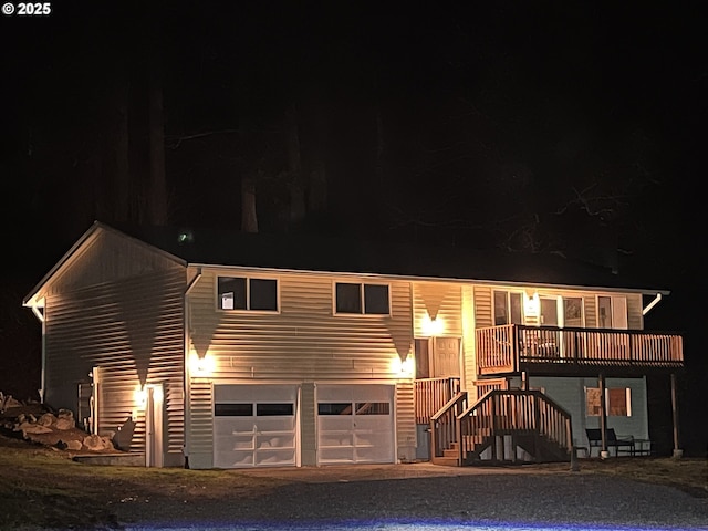 view of front of home with a garage and a wooden deck