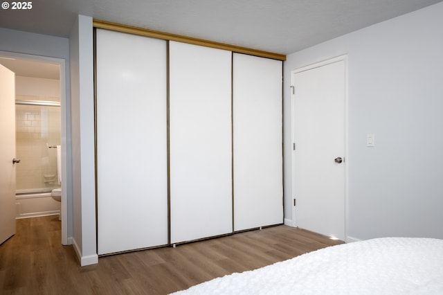 bedroom with a closet and wood finished floors