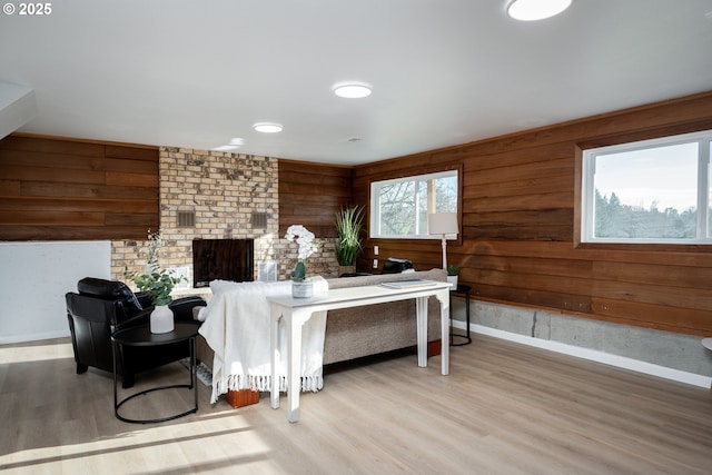 interior space featuring wood walls, baseboards, and wood finished floors