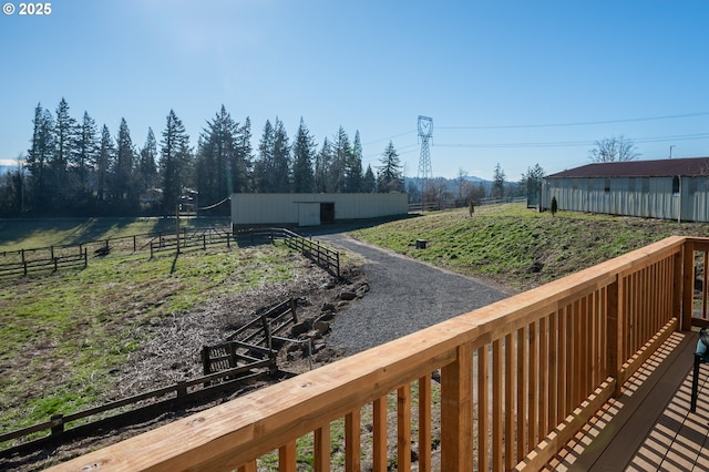 view of yard featuring a pole building, an outdoor structure, and fence