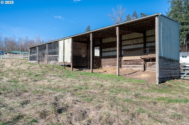 view of pole building with fence