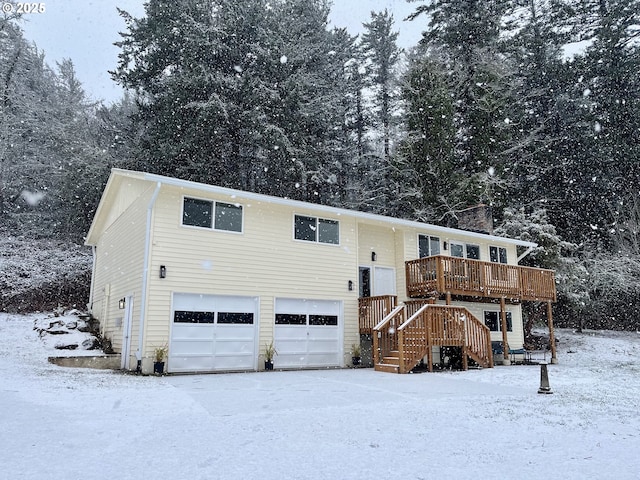 view of front of house with an attached garage, a chimney, stairway, and a deck