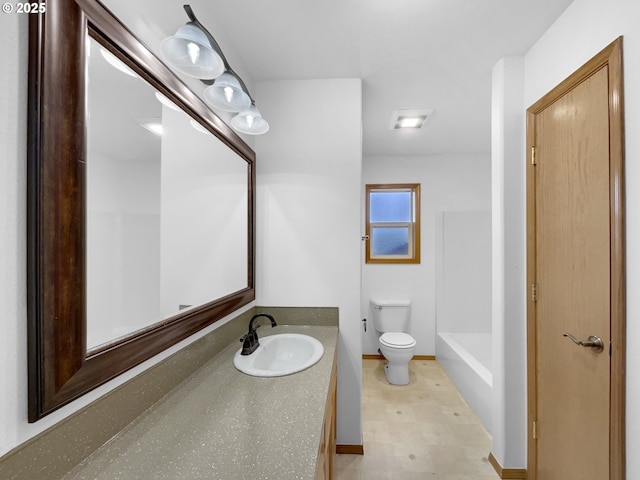 bathroom with toilet, baseboards, and vanity