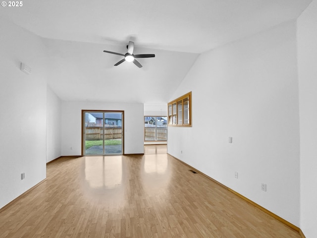 unfurnished living room featuring baseboards, visible vents, a ceiling fan, wood finished floors, and vaulted ceiling