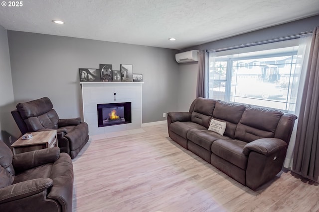 4260 Murnane St, Eugene, OR 97402 - living area with recessed lighting, a wall mounted air conditioner, a fireplace, and light wood-type flooring