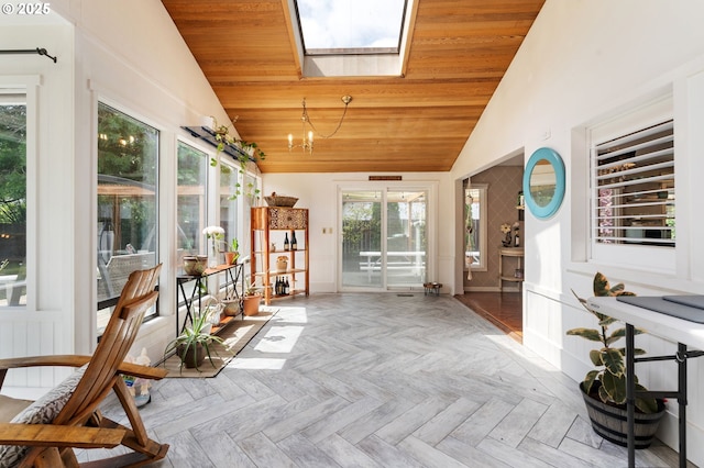 sunroom / solarium with a skylight and a chandelier