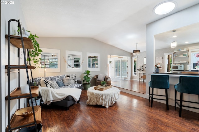 living room featuring wood finished floors and lofted ceiling
