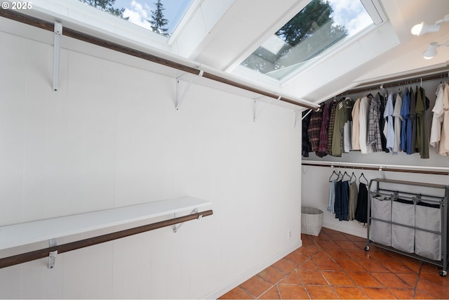 walk in closet featuring a skylight and tile patterned floors