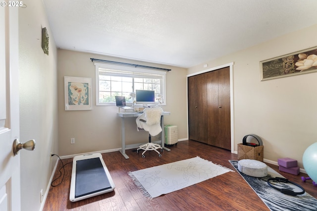 home office with baseboards and wood finished floors
