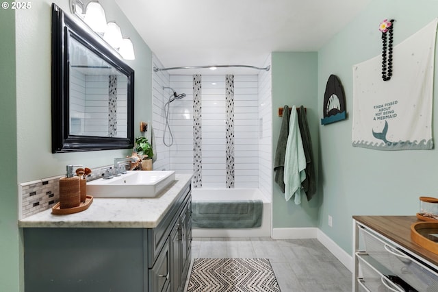 bathroom with vanity, shower / bathing tub combination, and baseboards