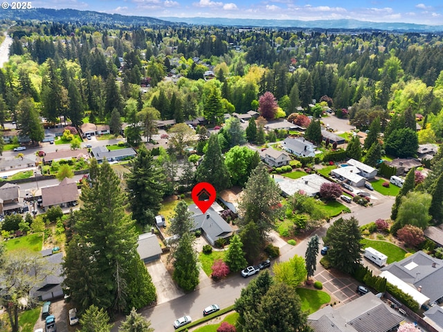 aerial view featuring a residential view and a wooded view
