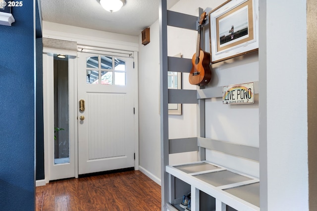 mudroom featuring baseboards and dark wood finished floors