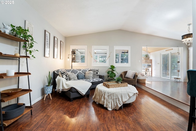living area featuring lofted ceiling, wood finished floors, and a healthy amount of sunlight