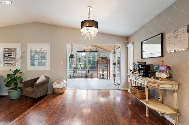 interior space featuring wallpapered walls, a chandelier, plenty of natural light, and vaulted ceiling