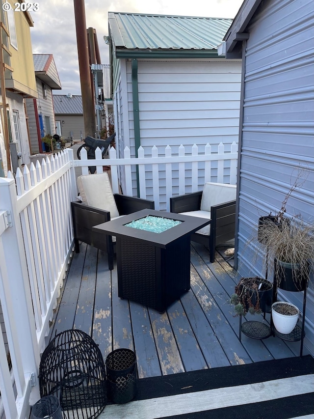 deck featuring an outdoor fire pit