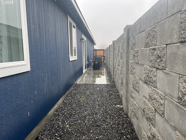 view of property exterior with fence and cooling unit