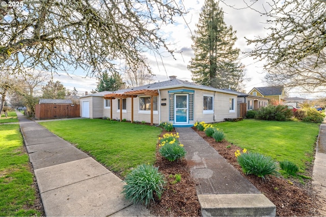 view of front of property featuring an outbuilding, a storage unit, and a front lawn